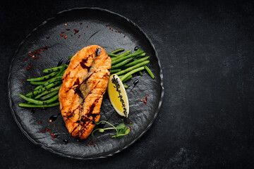 Grilled redfish steak with green beans and lemon