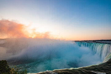 Sunrise over Horseshoe Falls closeup in the morning with mist at Niagara Falls in Canada