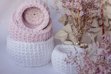 Purple cute decorative hand crocheted baskets, sustainable handicraft business, cozy home atmosphere with decorative purple dry  plants and white background
