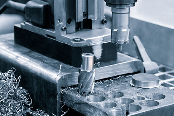 The Hi-precision CNC milling machine with cutting sample in blue-silver tone.The micro cutting...