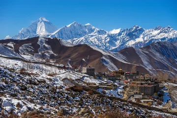 Fototapete Dhaulagiri Ranipauwa village and Mt. Dhaulagiri on the horizon in Kali Gandaki valley from Shree Muktinath Temple in autumn sunny day.