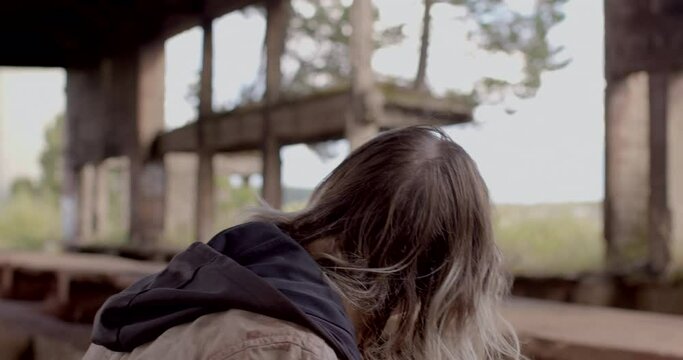 Head of unrecognizable addicted man, view from back, no face. Long messy hair. Drunken walk. Poverty is state of being extremely poor. Lack of income, individuals don't have the means to subsist.