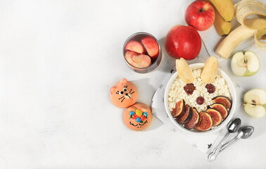 Healthy breakfast with ingredients, fun food for kids. Cottage cheese with figs and bananas, apples and grapes, top view, Healthy and natural food concept