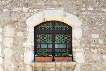Colorful window in the medieval village of Perouges in France	