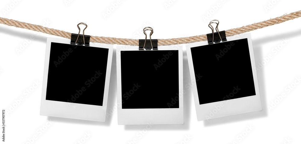 Wall mural Hanging instant photo frames isolated on white