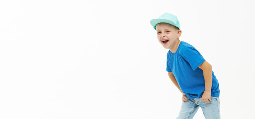 Stylish child boy laughing merrily with wide open mouth in a blue casual t-shirt and cap on a white isolated background