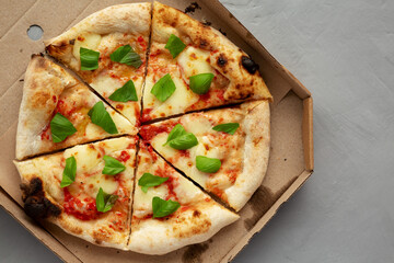 Organic Margarita Pizza with Basil and Mozarella in a Box, top view. Flat lay, overhead, from above.