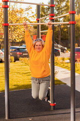 senior aged woman doing exercises on the sports ground outdoor