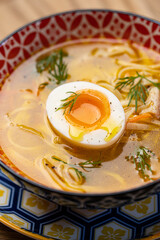 soup with noodles and egg in a restaurant