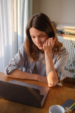 Woman working on laptop from home online payment