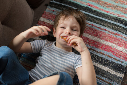 portrait of a child with bread in his mouth