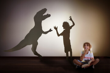 Dinosaur shadow in child dream. Kids read, imagine