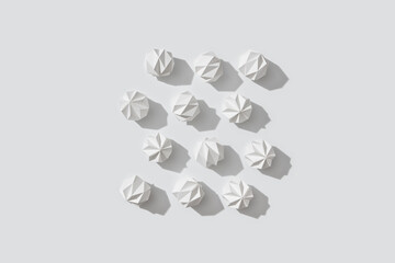 White paper snowballs laid out in rows.