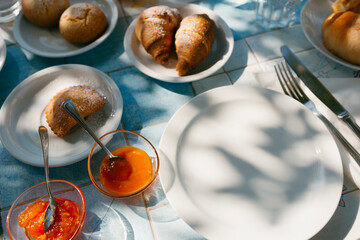 Breakfast in sunlight on blue and white tiles table