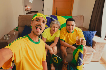 Brazilian Mixed Race Family Celebrating the cup in the living room watching football game. Family...
