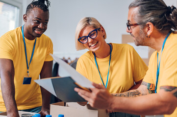 Group of multiracial volunteers working in community charity donation center