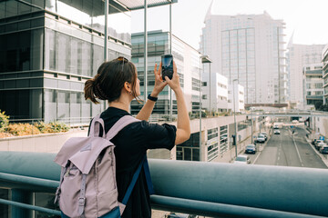 Female tourist taking photos with her phone