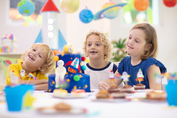 Kids space theme birthday party with cake.