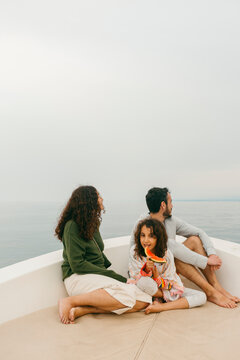 Kid eating watermelon aboard a small boat with her family
