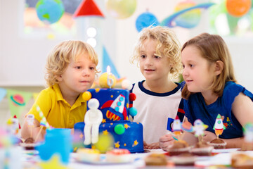 Kids space theme birthday party with cake.