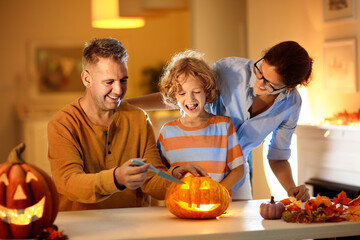 Family carving pumpkin. Halloween trick or treat