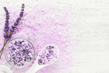 Lavender aroma bath salt and lavender flowers on white background. Spa, skincare concept. Soft focus