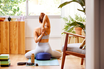 Woman doing Cow Face pose variation