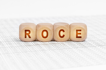 On the table with documents are wooden cubes with the inscription - ROCE