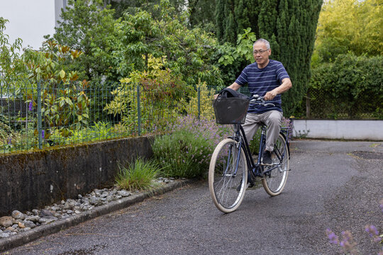 senior man riding bicycle, commute by bike