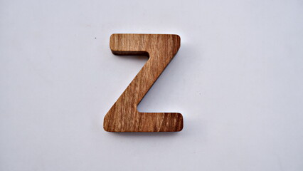 Wooden textured alphabet letters on a white background , selected focus isolated photo