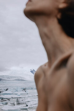 Close-up neck and chest of a nude woman near glacier lagoon in Iceland