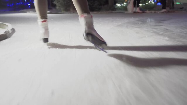 close-up of a girl's legs on ice skate