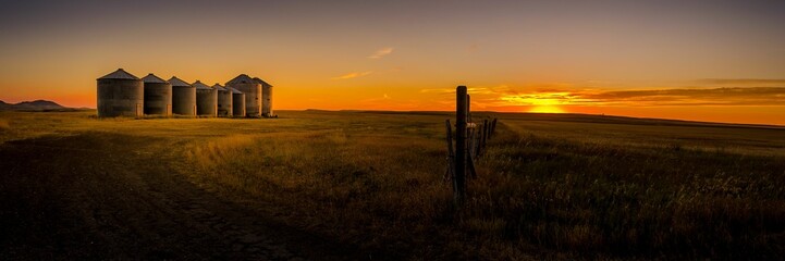 Panoramic shot of grain silos in Montana during the sunset