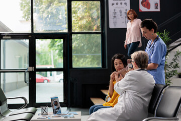 Fototapeta premium Medical assistant and medic helping senior woman with cervical neck collar, giving support to remove foam brace and recover. Specialists helping injured patient with fracture, medicine support