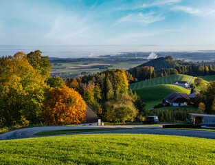 Peaceful autumn sunny morning rural view from Gmundnerberg with misty countryside in far, Austria.