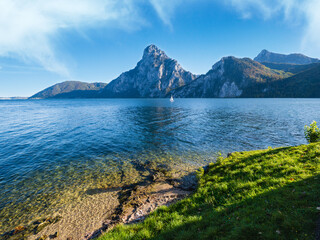 Peaceful autumn Alps mountain lake. Morning view to Traunsee lake and Traunstein mountain in far, Upper Austria.