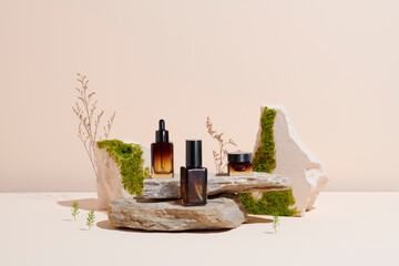 glass containers for natural cosmetics on a podium made of stones