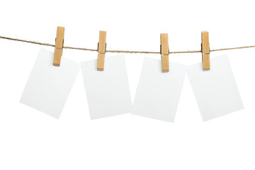 Blank white papers hanging on rope isolated on white background