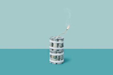 Dynamite-shape dollar bundle with burning wick.
