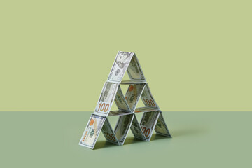 Dollar banknotes folded and laid in pyramid form.