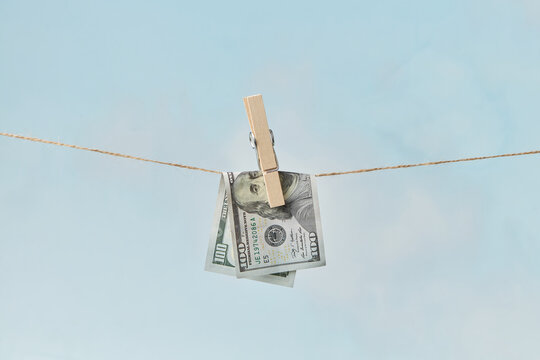 Dollar bill drying on clothesline.