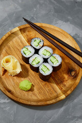 Sushi Maki rolls cucumber. Fresh hosomaki pieces with rice and nori. Close Up of delicious japanese food with sushi roll.