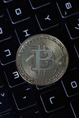 Golden bitcoin on laptop keyboard