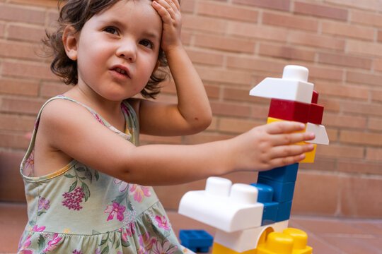 Little girl playing building block