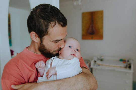 father holding little daughter