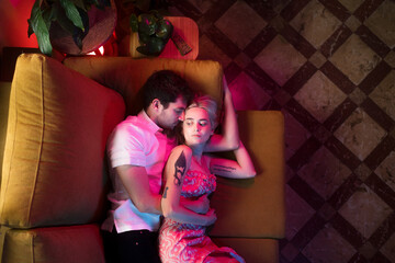 Dreamy couple hugged on the sofa