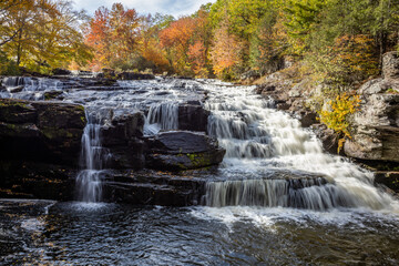 Fototapeta na wymiar Shohola Falls in the Poconos, PA, looks amazing with beautiful fall foliage and lots of graceful cascades