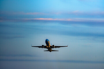 Airplane in the sky at sunset