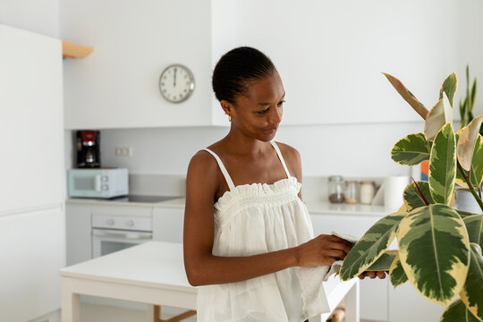 Woman caring plants at home