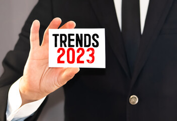 Text TRENDS 2023 on white paper between white and brown spiral notepads.